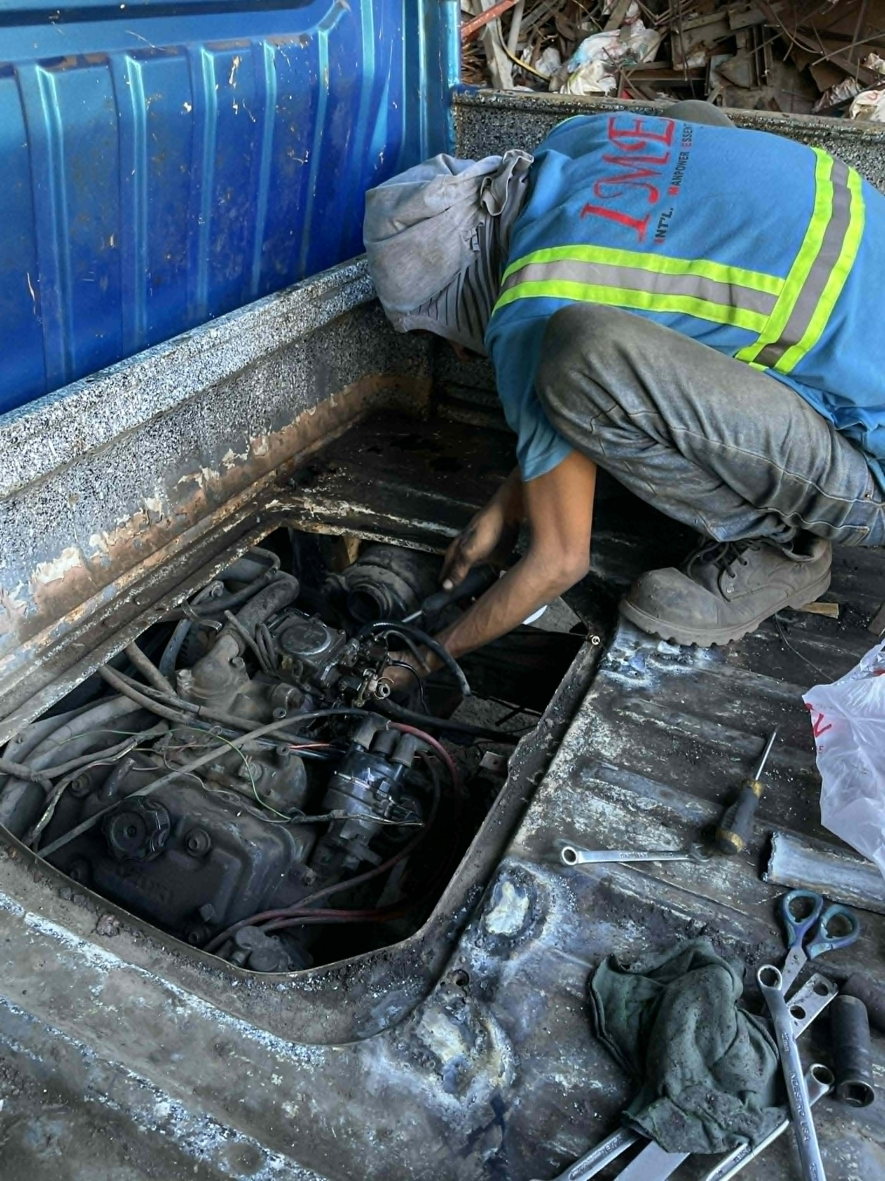 Mechanic repairing vehicle engine